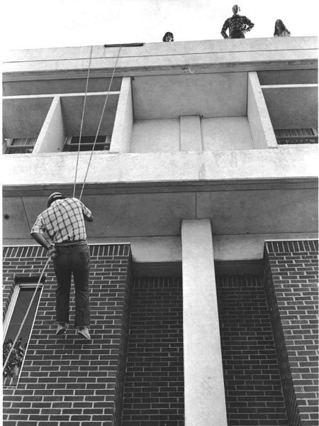 1975 Mountaineer Club.jpg - Bob Benner gives the Mountaineer Club practical experience by having them repel down the side of the school buildings - 1975